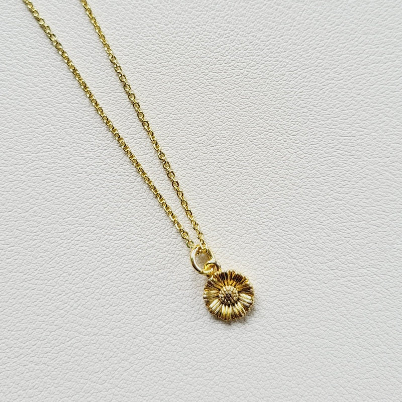Gold tone flower charm necklace