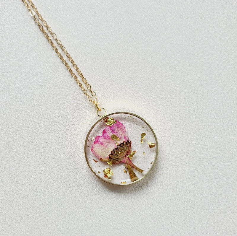 Gold tone dried flower resin pendant necklace