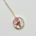 Gold tone dried flower resin pendant necklace