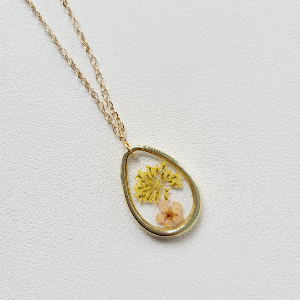 Gold tone dried yellow flower resin pendant necklace