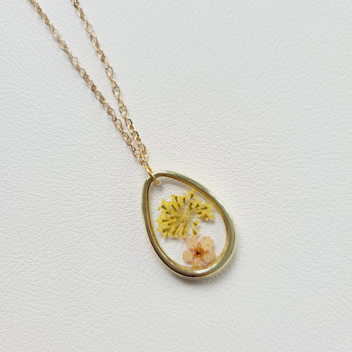 Gold tone dried yellow flower resin pendant necklace