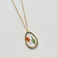 Gold tone dried flower resin pendant necklace
