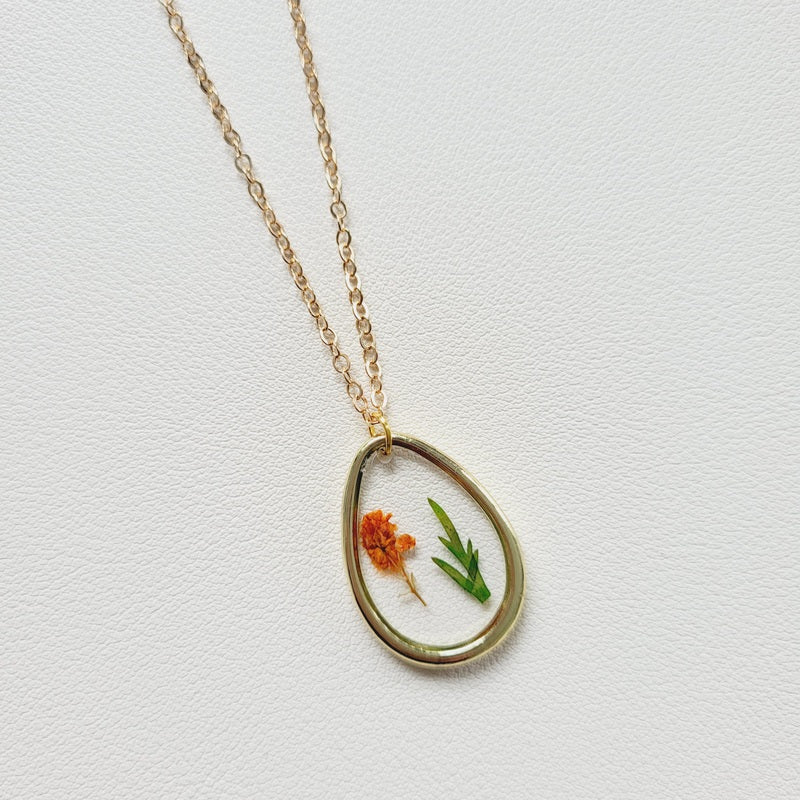 Gold tone dried flower resin pendant necklace