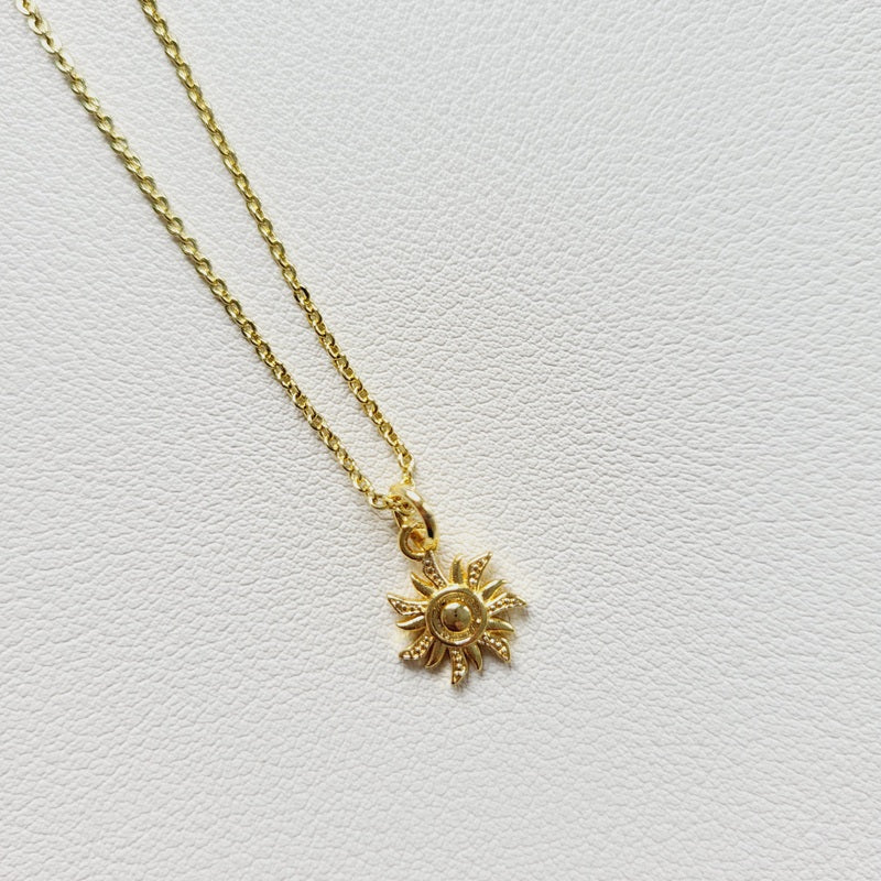 Gold tone sun charm pendant necklace