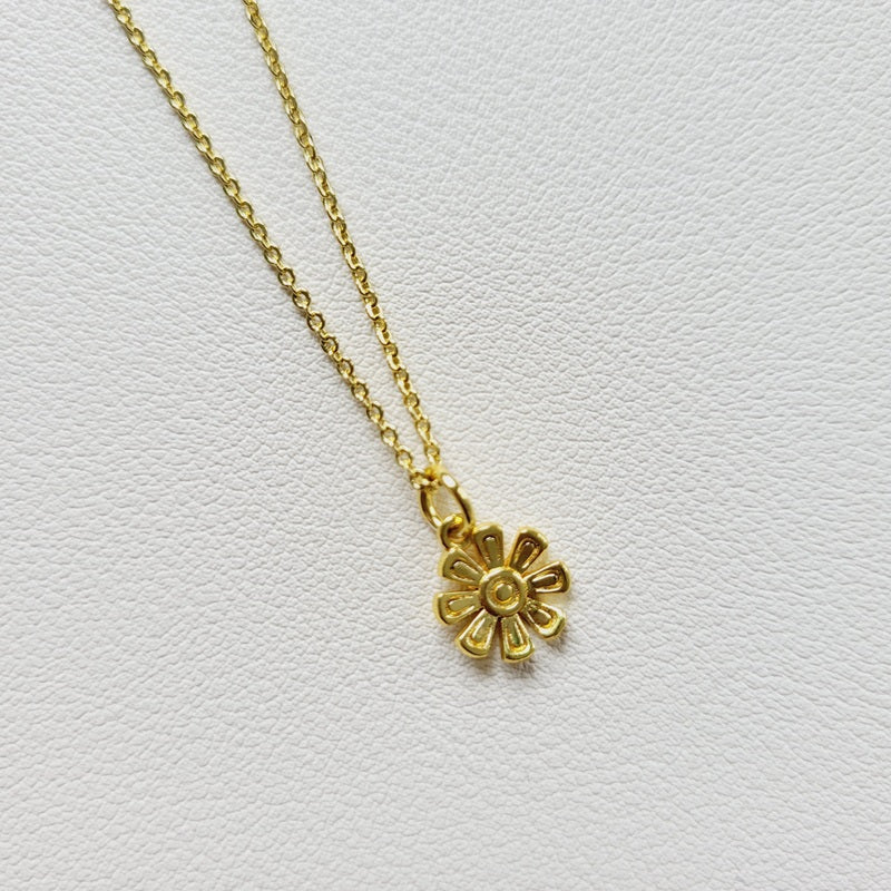Gold tone flower charm necklace