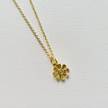 Gold tone flower charm necklace