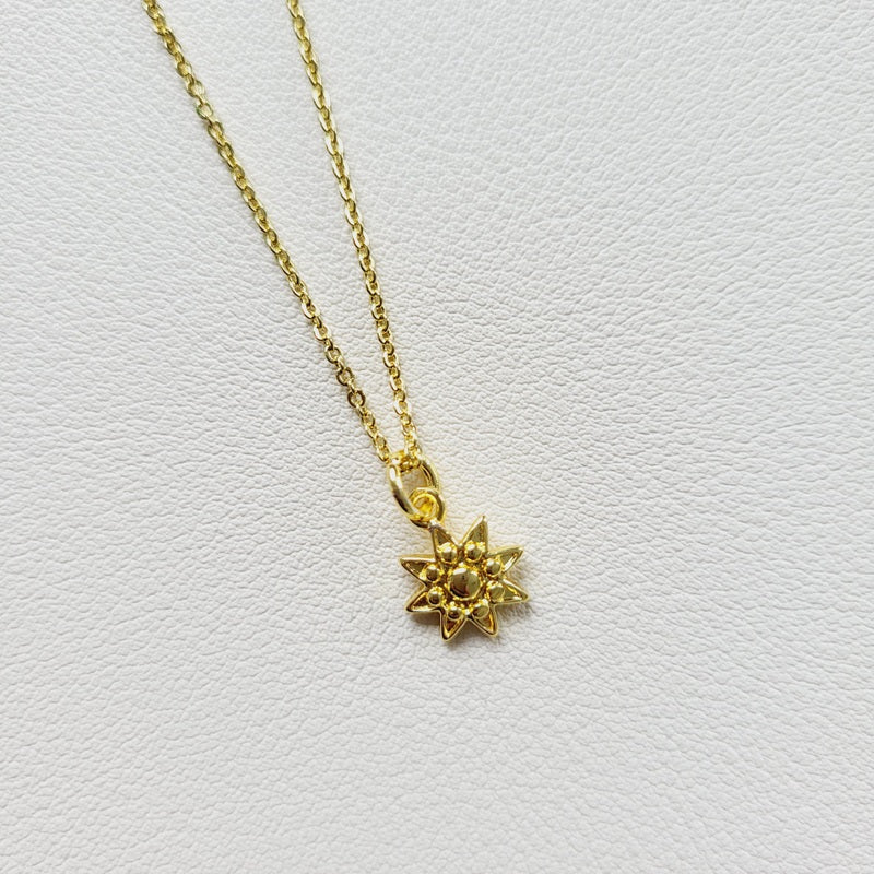 Gold tone sun charm pendant necklace
