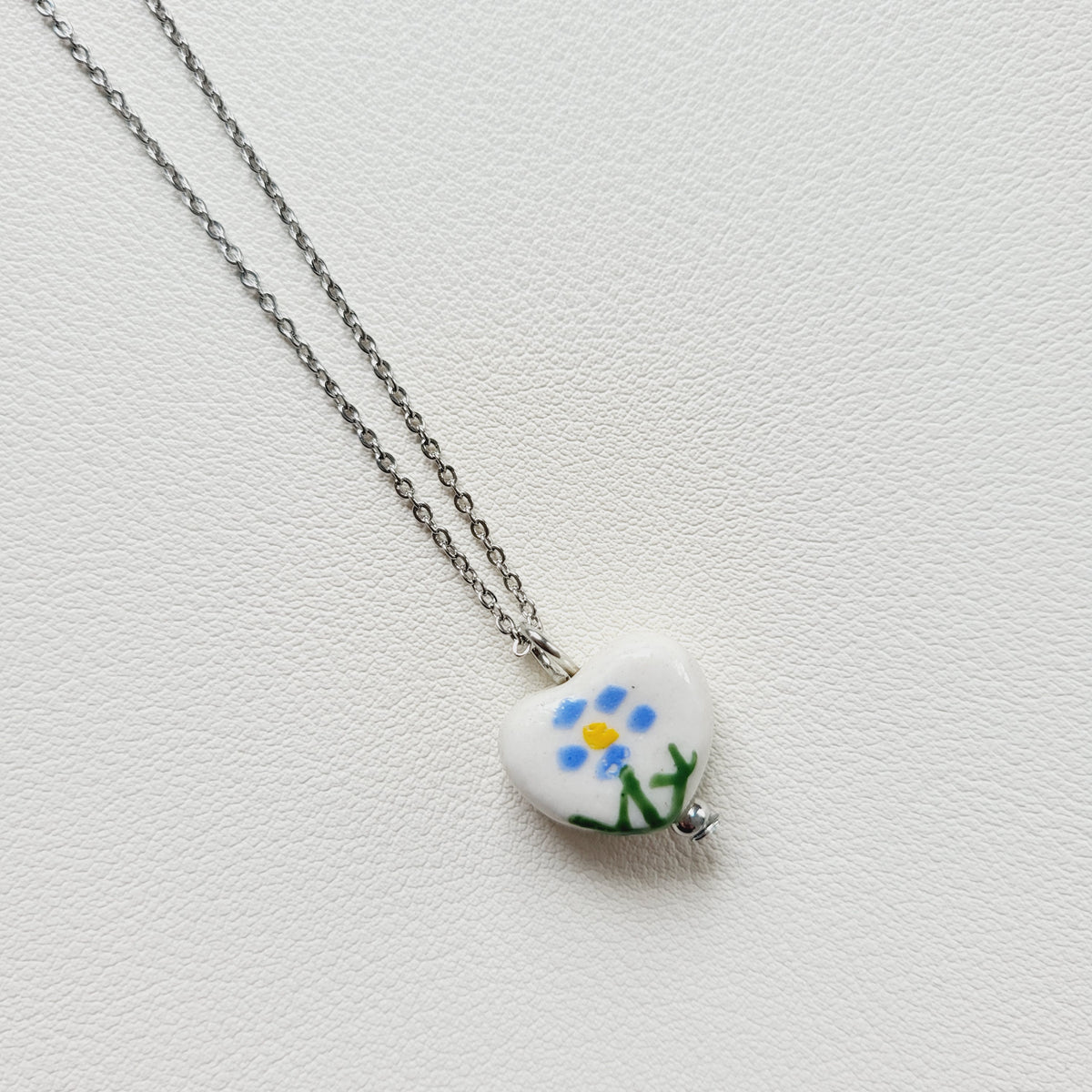 Flower design ceramic white heart charm with silver tone chain necklace (blue)