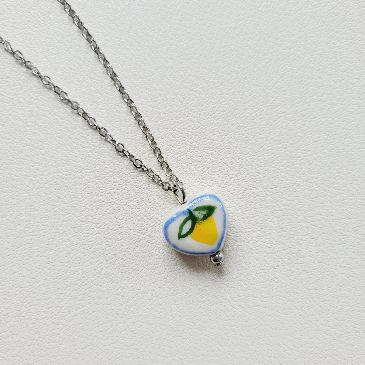 Lemon design ceramic white heart charm with silver tone chain necklace
