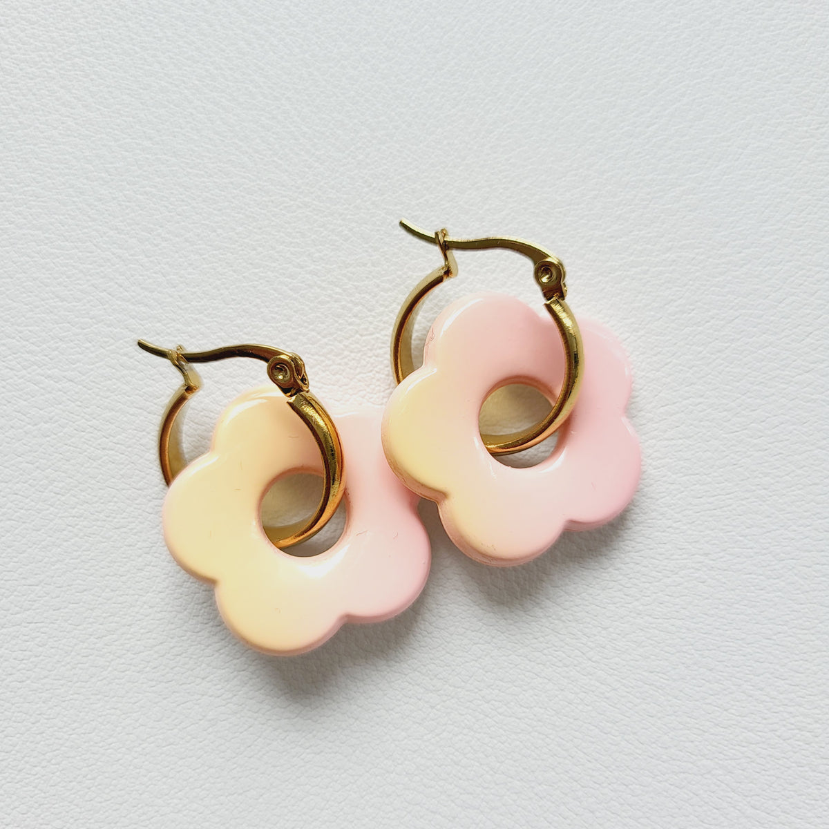Flower charm gold tone hoop earrings