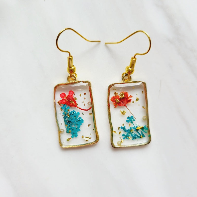 Gold tone blue flower resin drop dangle earrings