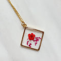 Gold tone dried red flower resin pendant necklace