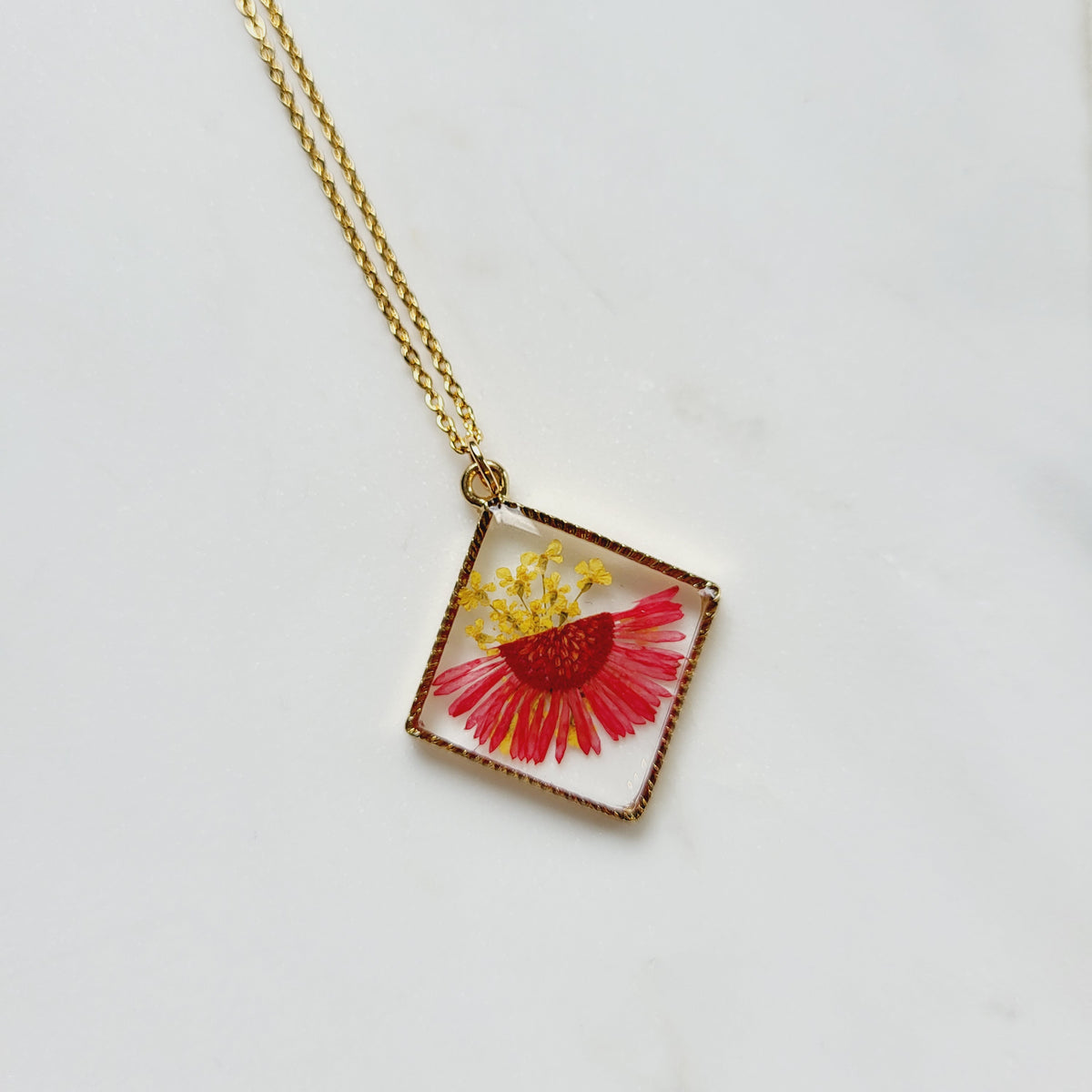 Gold tone dried red flower resin pendant necklace