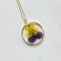 Gold tone dried primrose flower resin pendant necklace