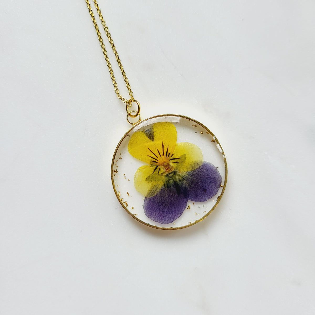 Gold tone dried primrose flower resin pendant necklace