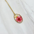 Gold tone dried red flower resin pendant necklace