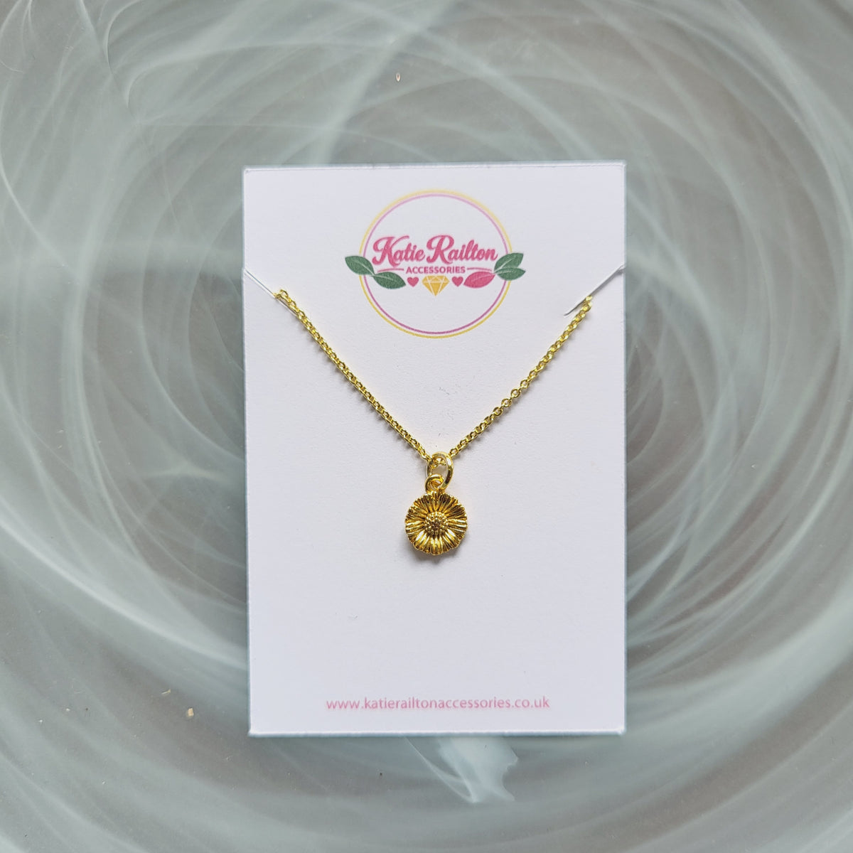 Gold tone flower charm necklace