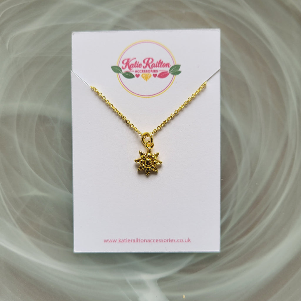Gold tone sun charm pendant necklace