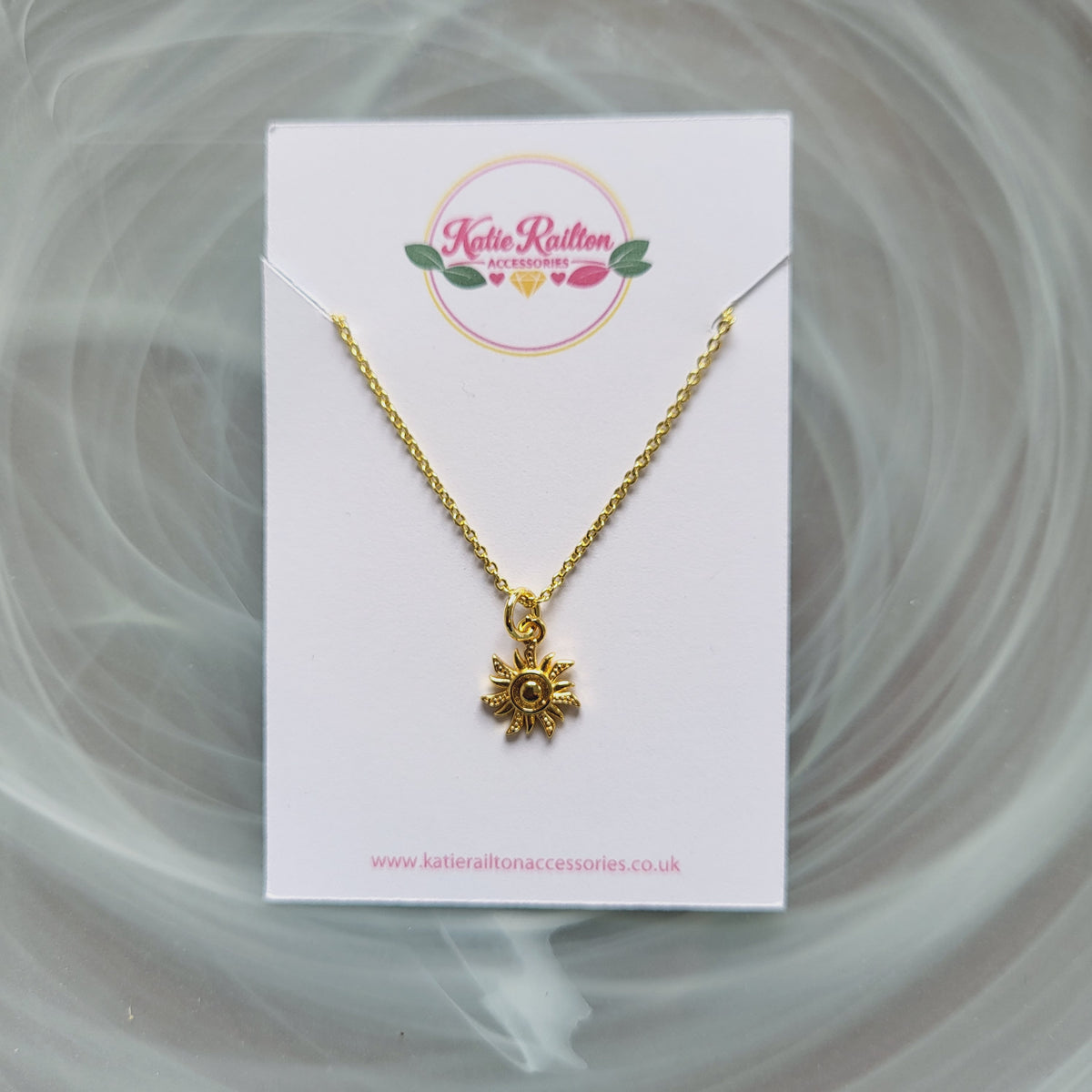 Gold tone sun charm pendant necklace