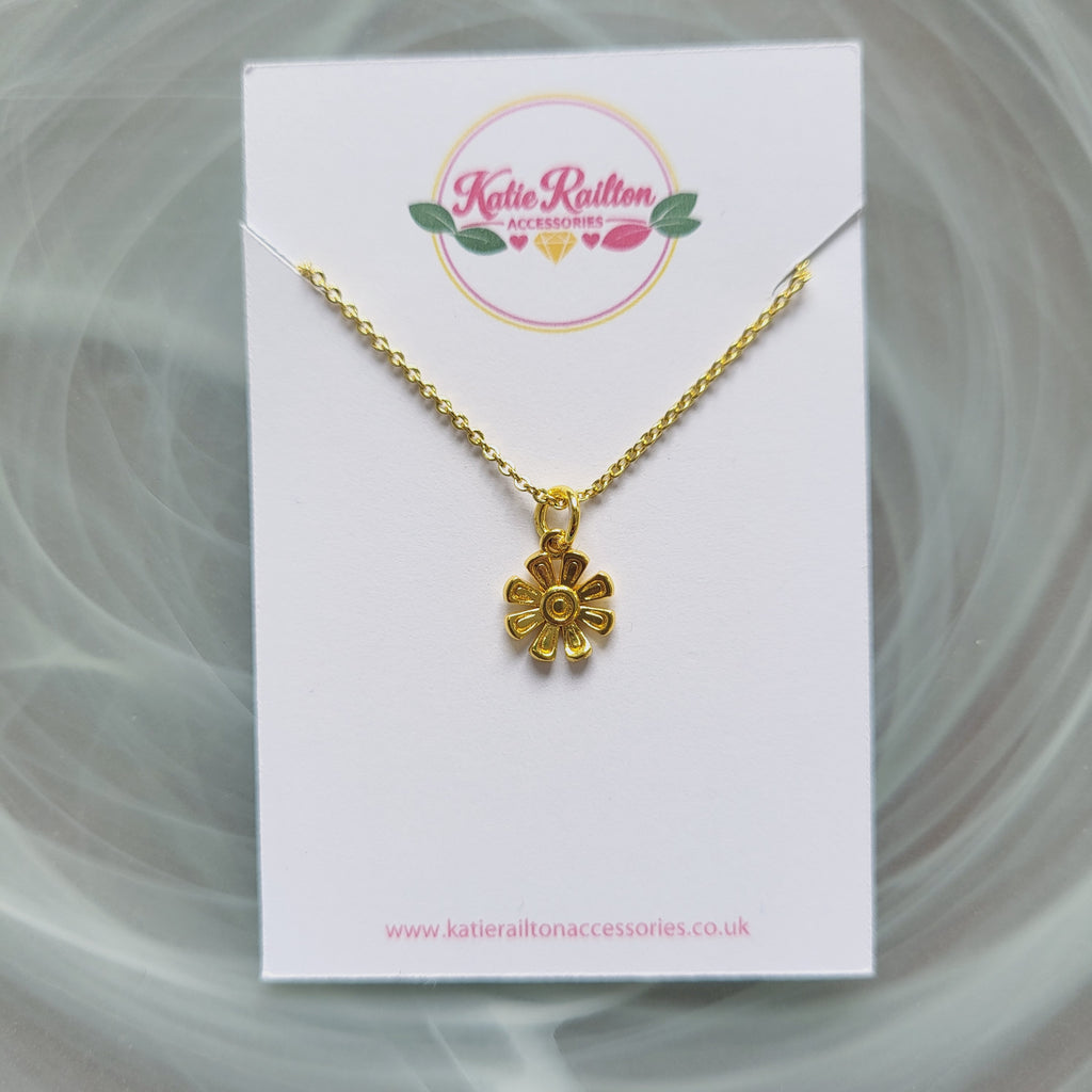 Gold tone flower charm necklace