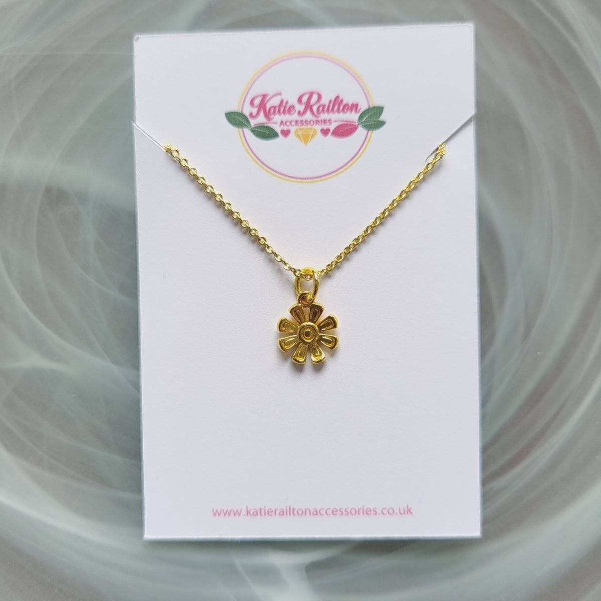 Gold tone flower charm necklace