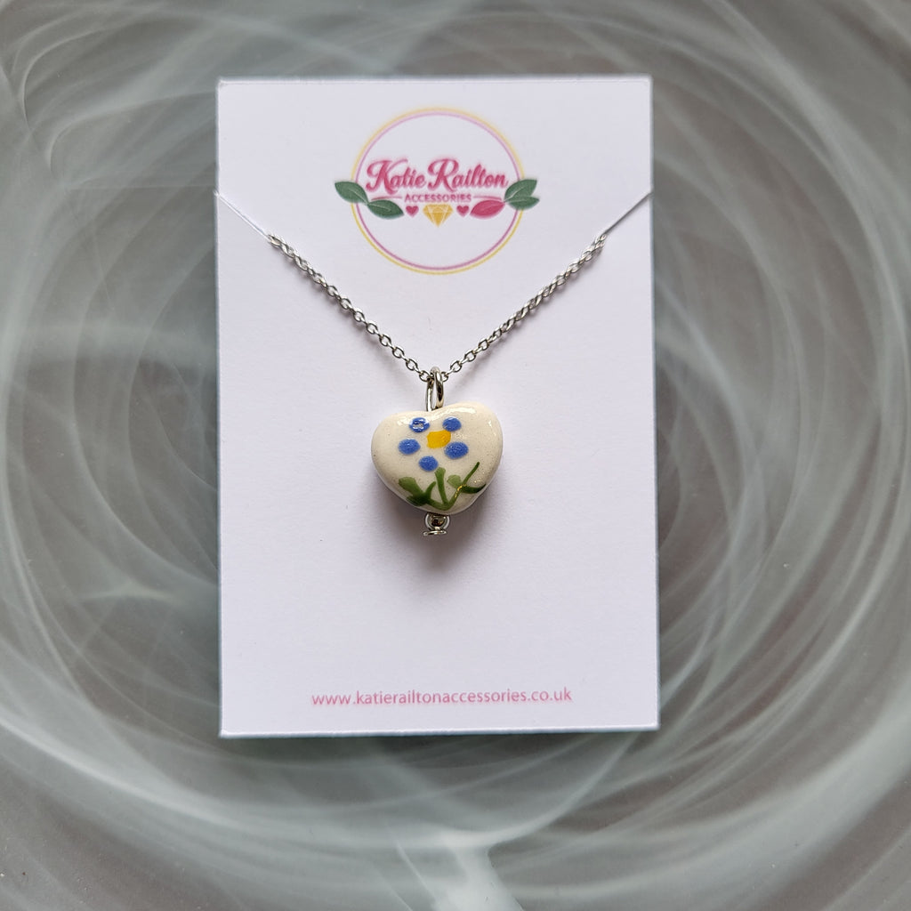 Flower design ceramic white heart charm with silver tone chain necklace (blue)