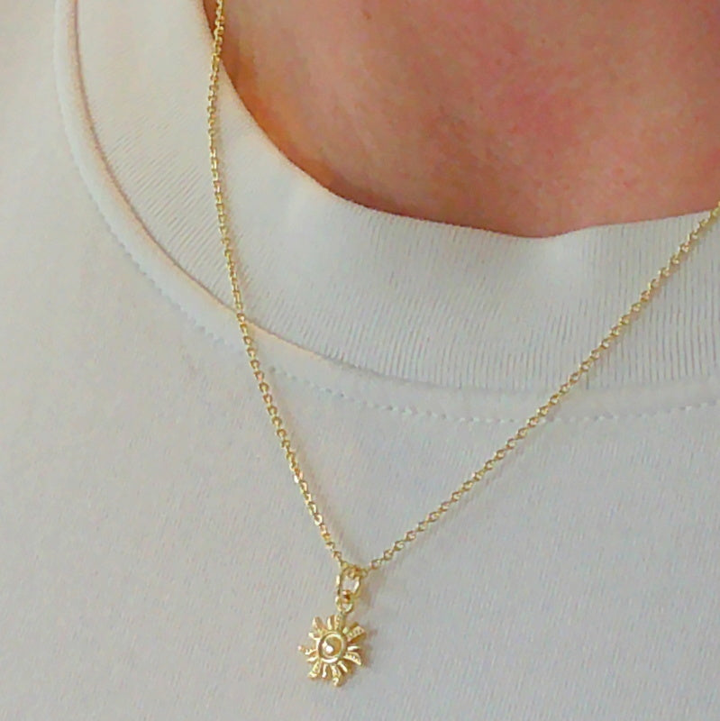 Gold tone sun charm pendant necklace