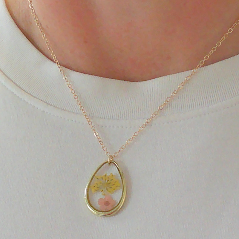 Gold tone dried yellow flower resin pendant necklace
