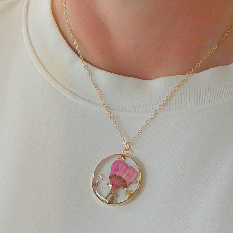 Gold tone dried flower resin pendant necklace
