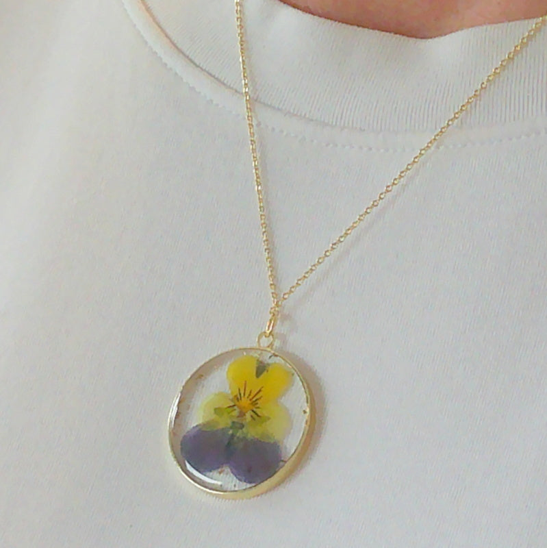 Gold tone dried primrose flower resin pendant necklace